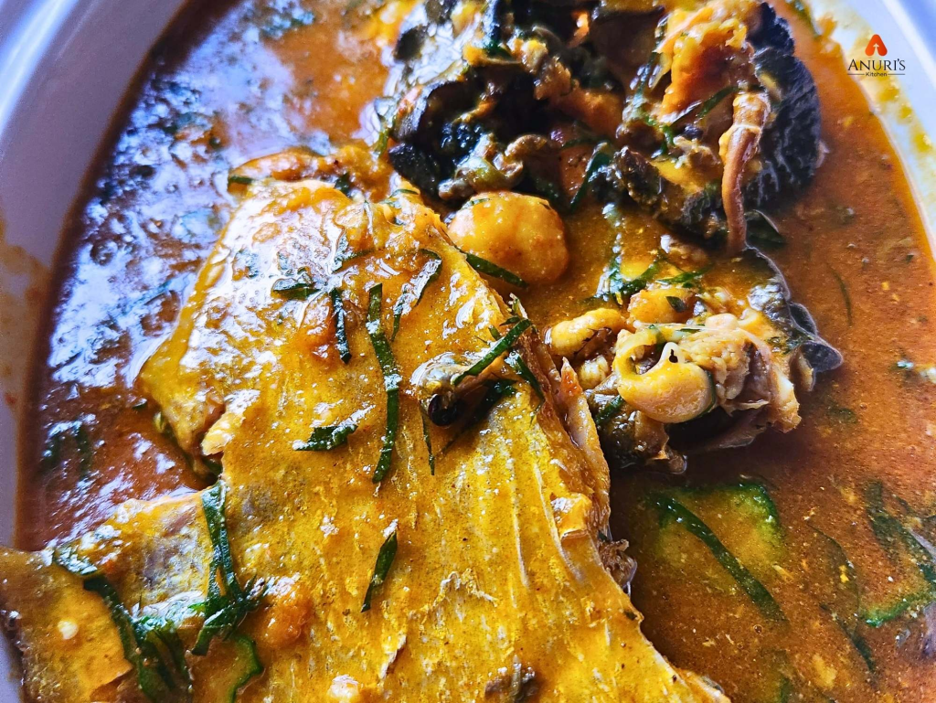 White bowl of well-plated fisherman’s soup with mixed seafood in a rich broth