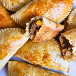 Well baked meat pie with gold crust served on a clean surface
