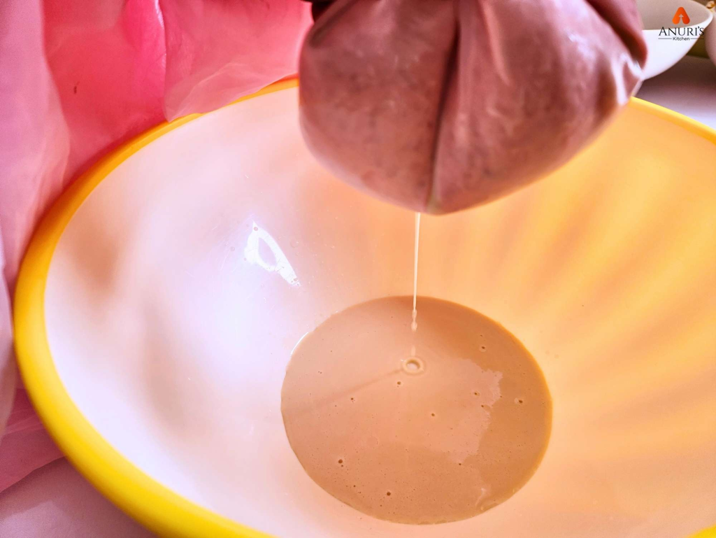 Straining the blended ingredients in a bowl