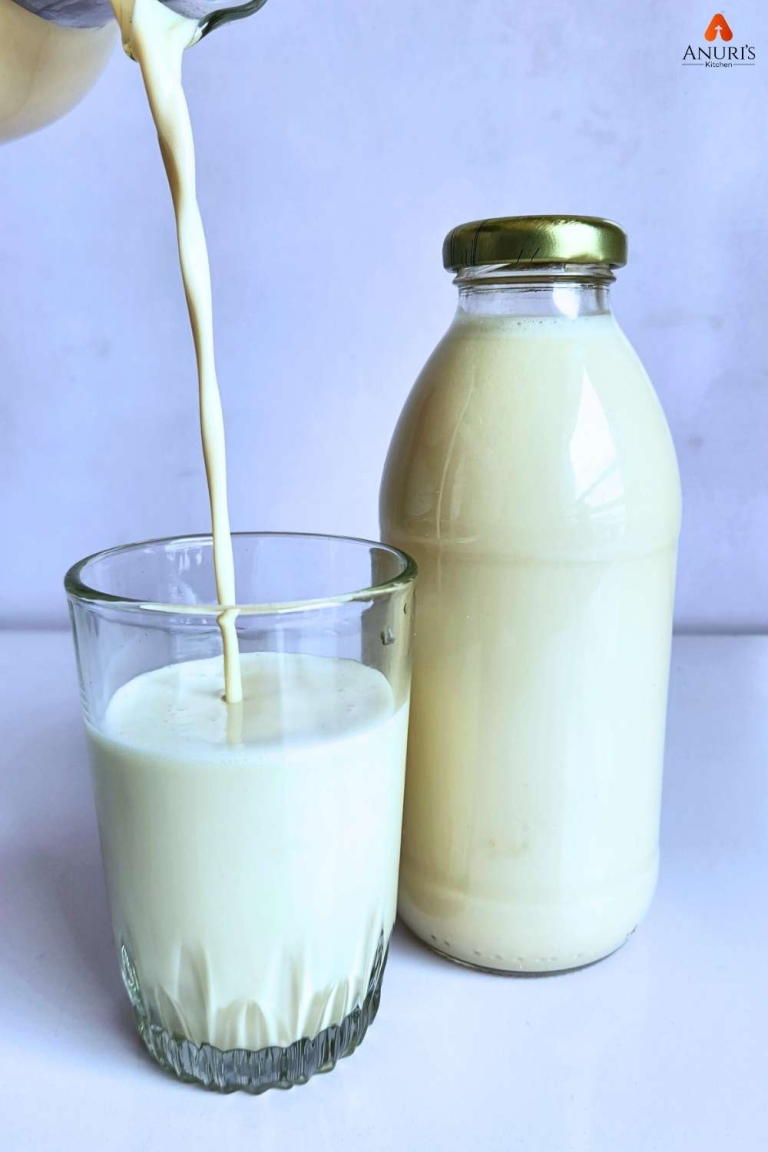 Sweetened coconut milk served in a glass cup and some in a jar