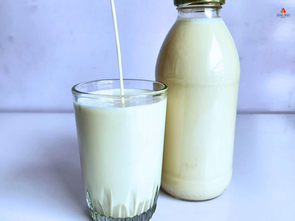 Sweetened coconut milk served in a glass cup and some in a jar