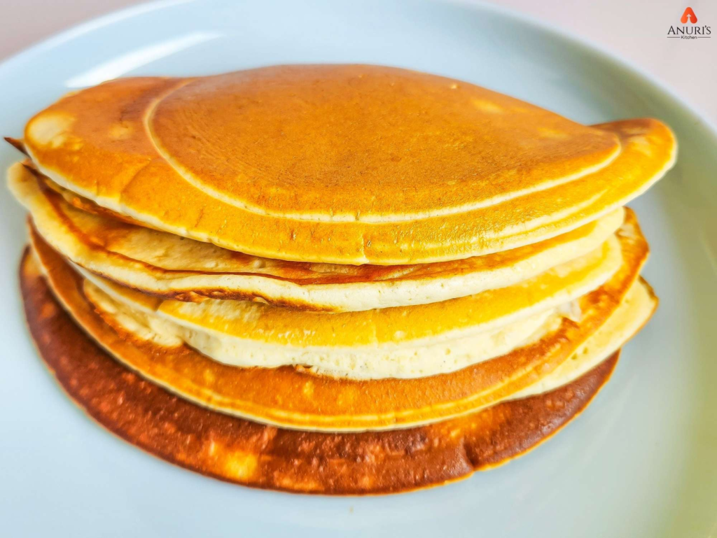 Pancakes served on a white dish.